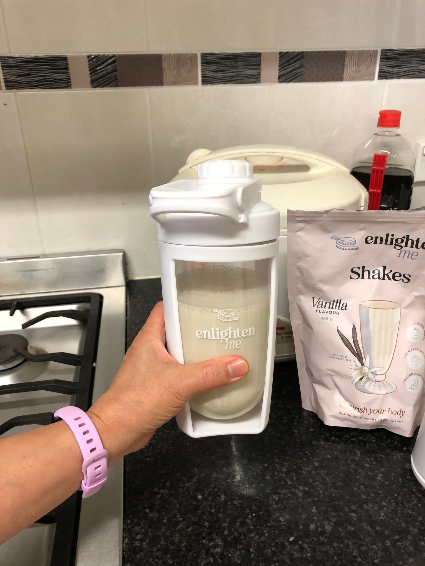 Liza holding a Vanilla Enlighten Me Shake