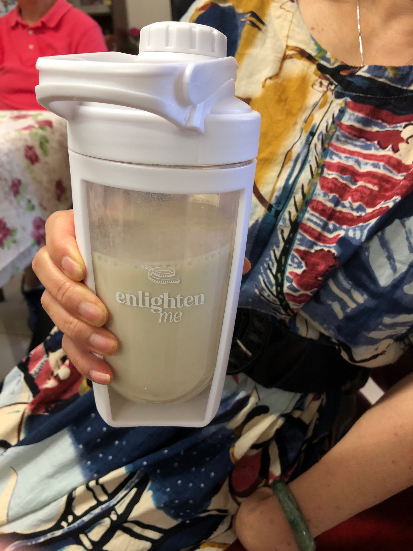 Nancy holding a Vanilla Enlighten Me Shake