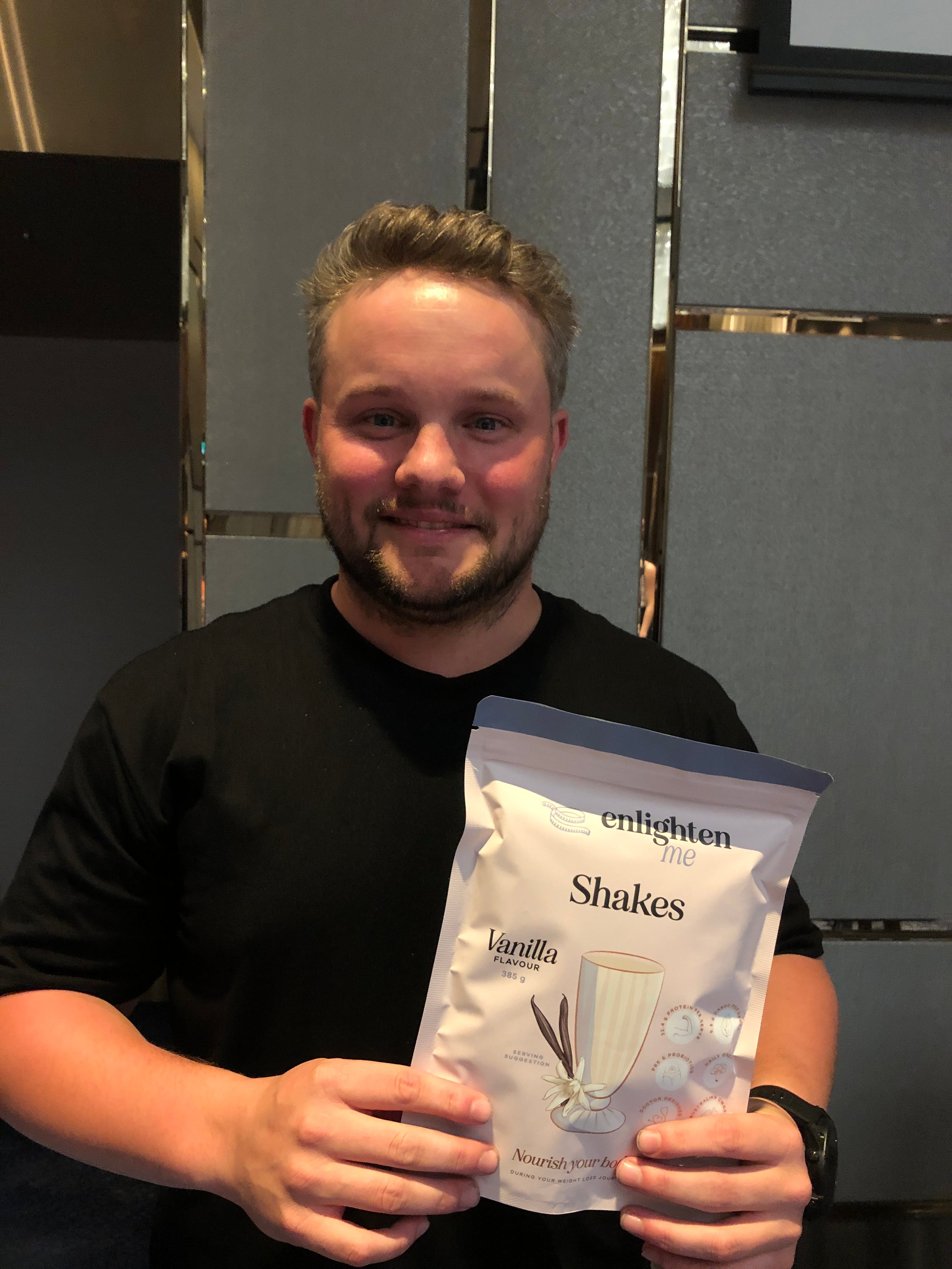 Ryan holding a Vanilla Enlighten Me Shake