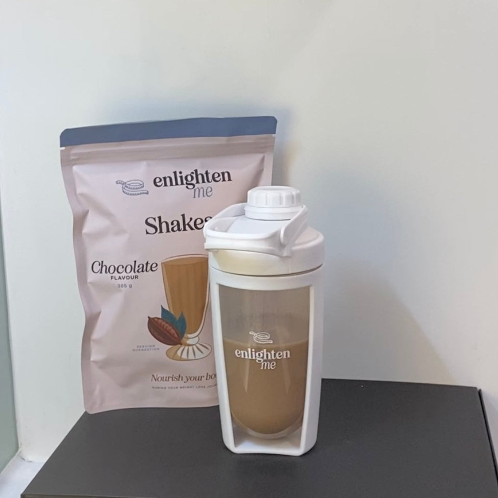 A demonstration picture of the Enlighten Me Shake in Chocolate Flavour, a high protein meal replacement shake for weight loss, being served in the Enlighten Me Shaker. 