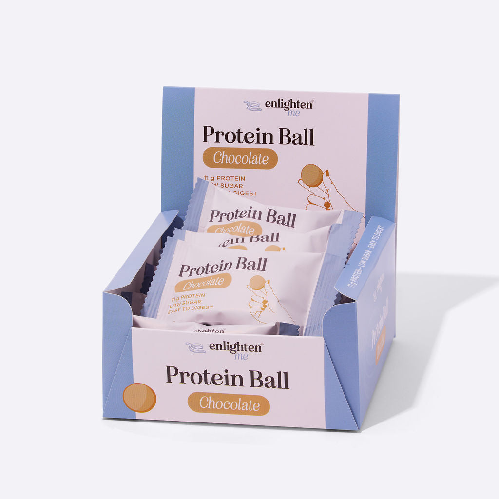 An open retail display box of Enlighten Me Chocolate Protein Balls, filled with individually wrapped 11g-protein, low-sugar snack balls.