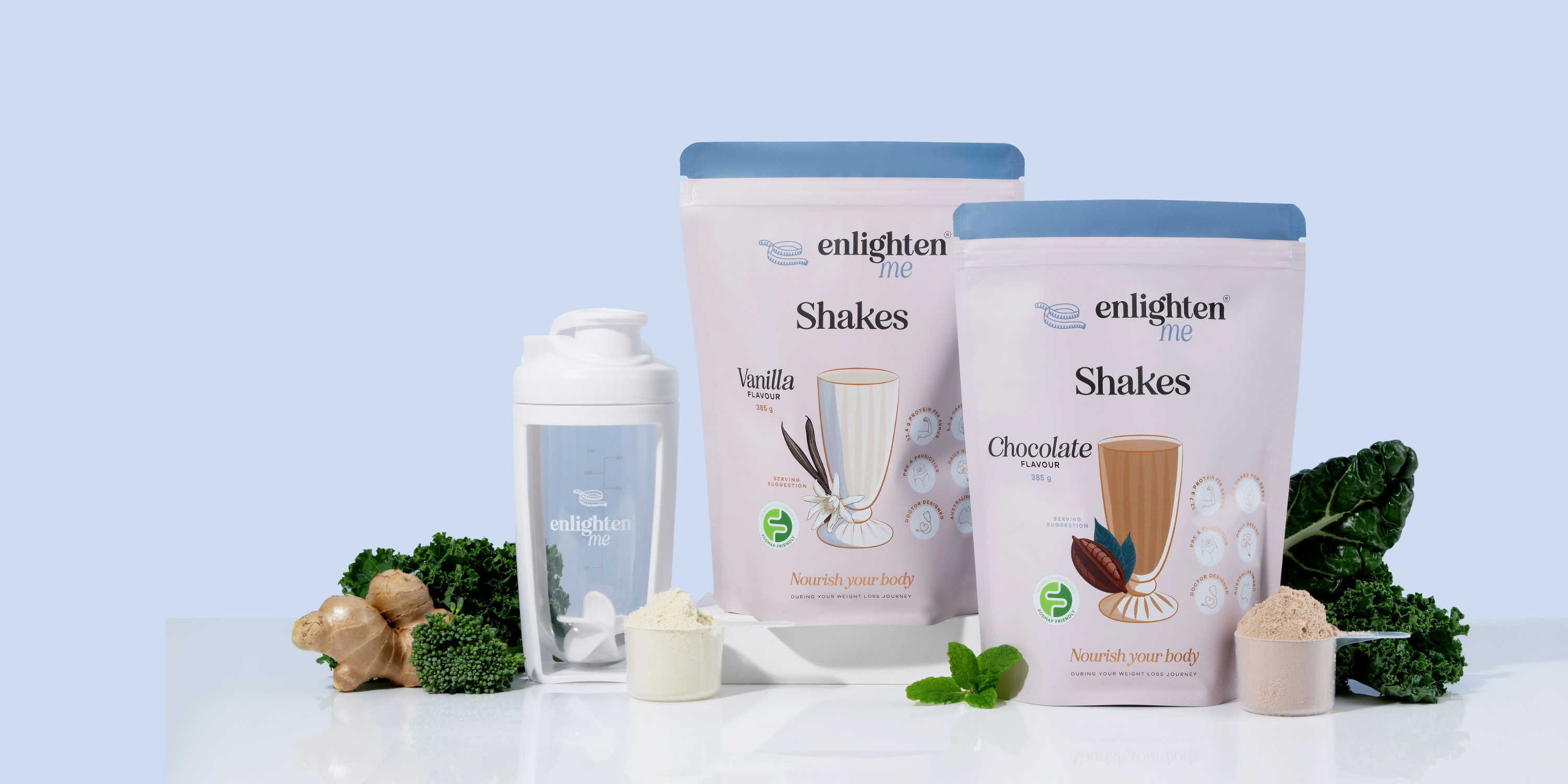 Two bags of Enlighten Shakes on a white surface with a white shaker on a light blue background