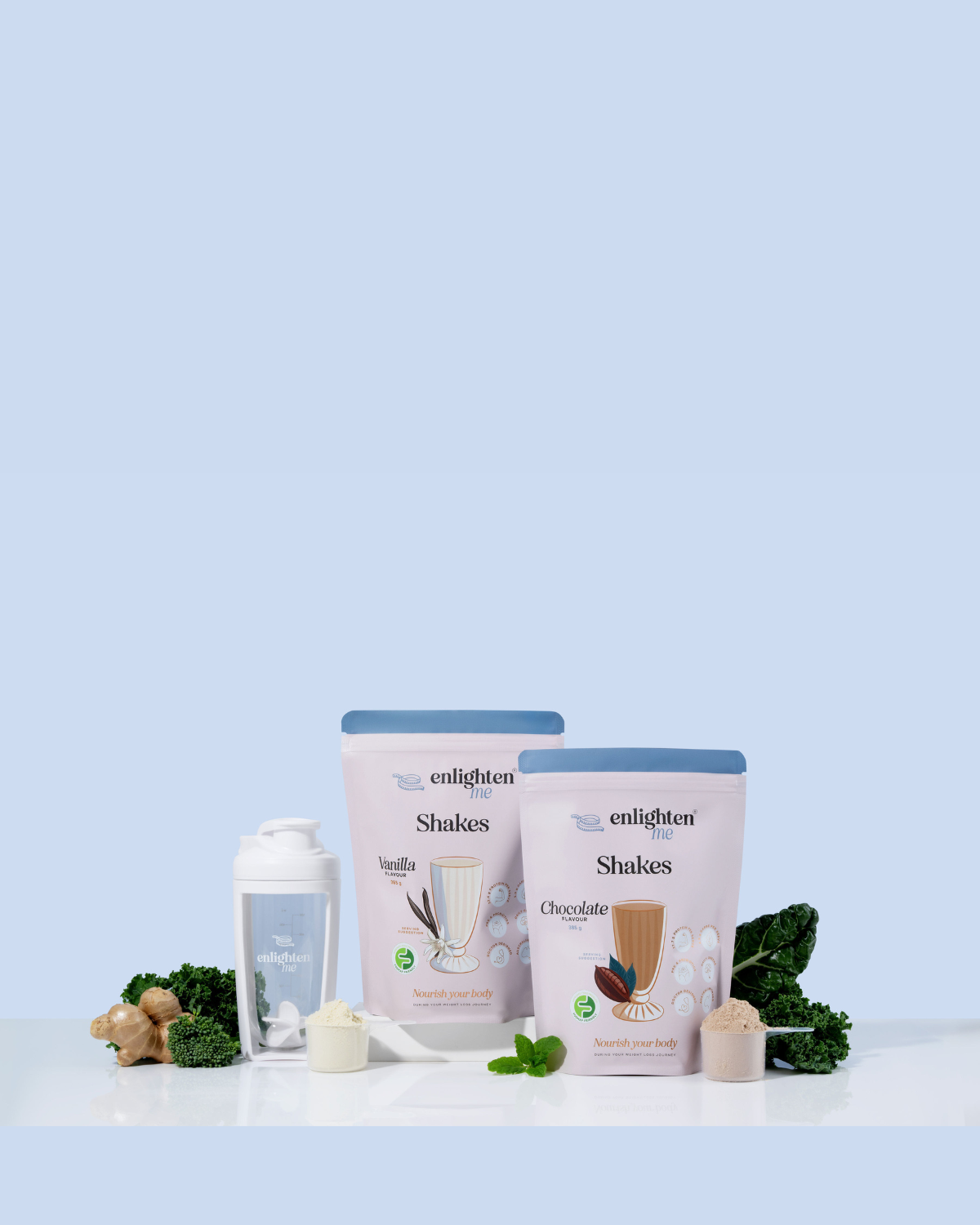 Two bags of Enlighten Shakes on a white surface with a white shaker on a light blue background