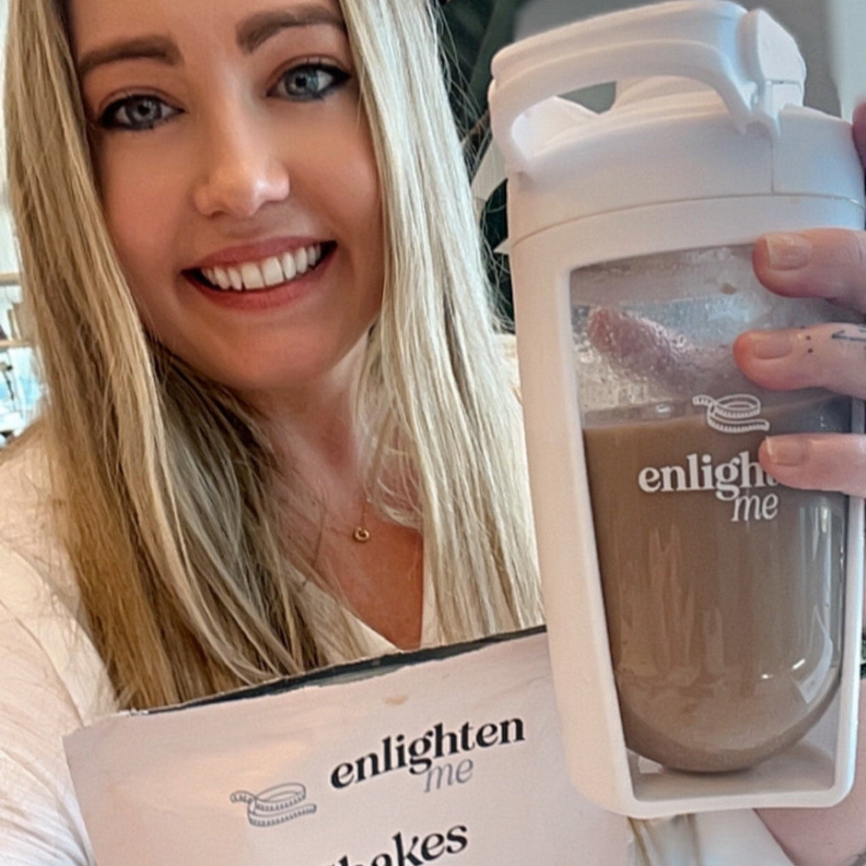 Gen holding an Enlighten Me Chocolate Shake.
