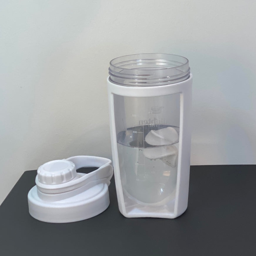 A demonstration picture of the Enlighten Me Shaker being filled with 300mls of water in preparation for creating an Enlighten Me Shake, a high protein meal replacement shake for weight loss. 