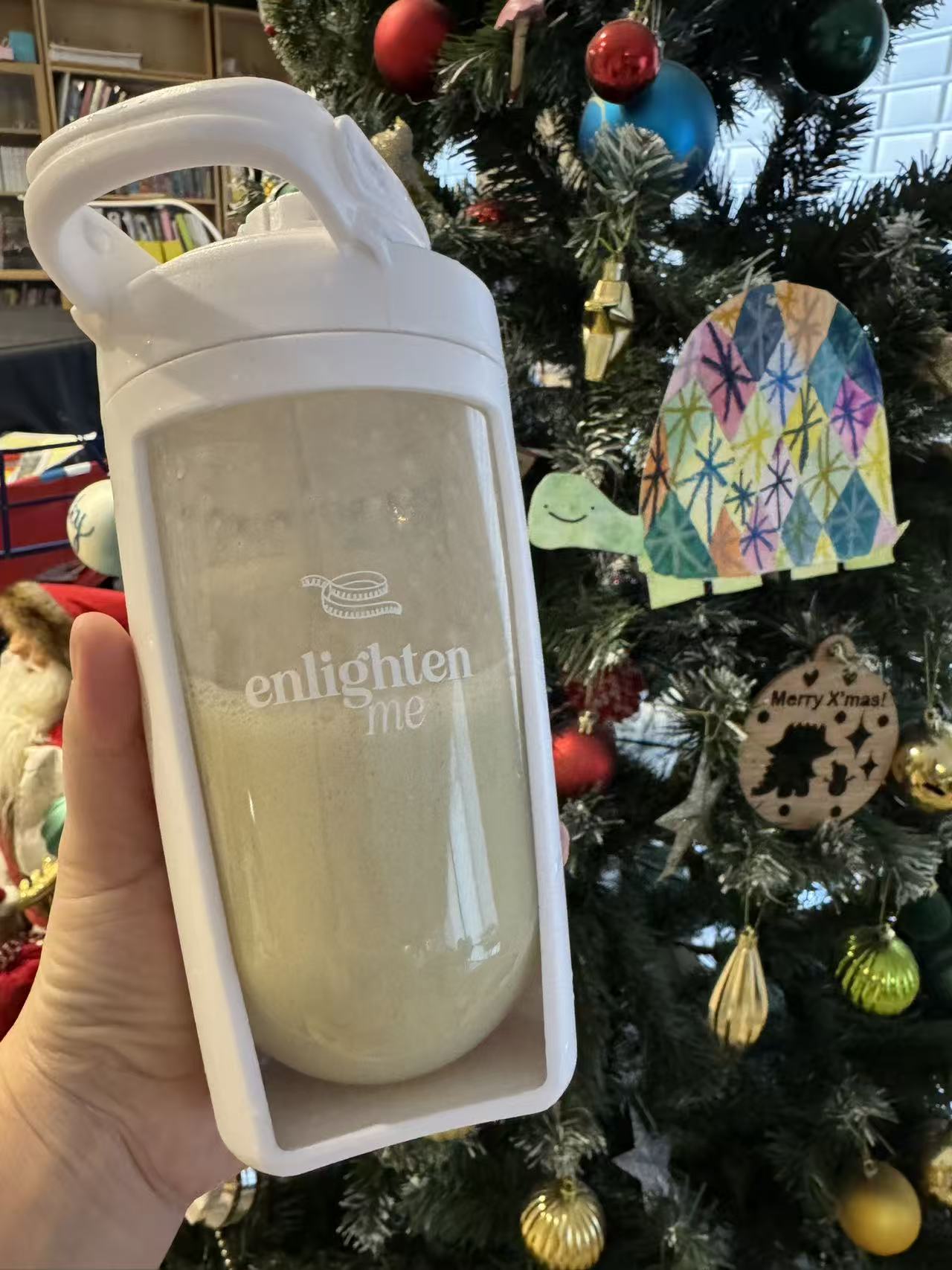 An Enlighten Me customer holding a Vanilla Shake.