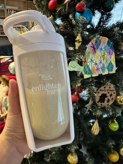 An Enlighten Me customer holding a Vanilla Shake.